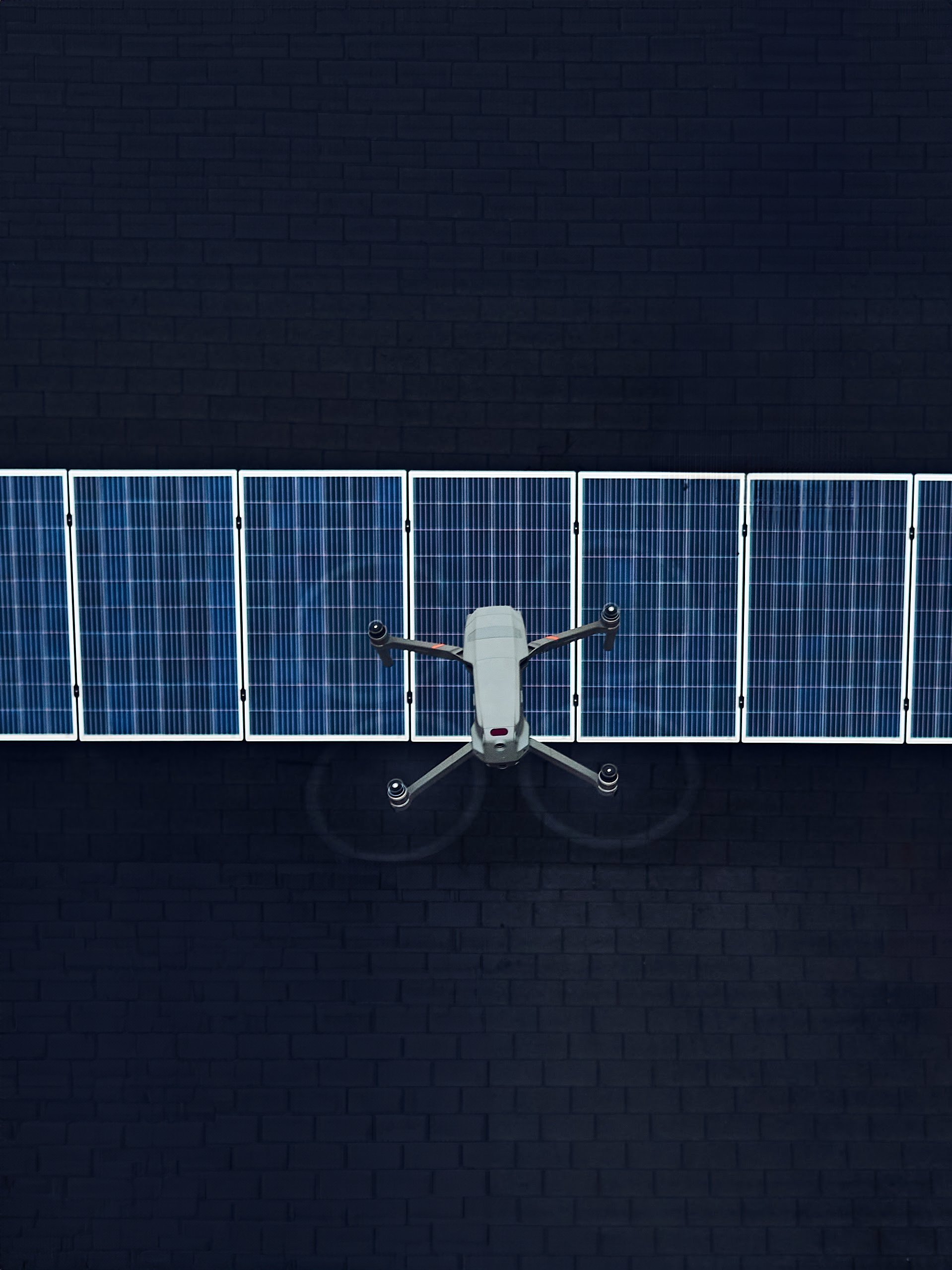 Aerial view of a drone flying over solar panels