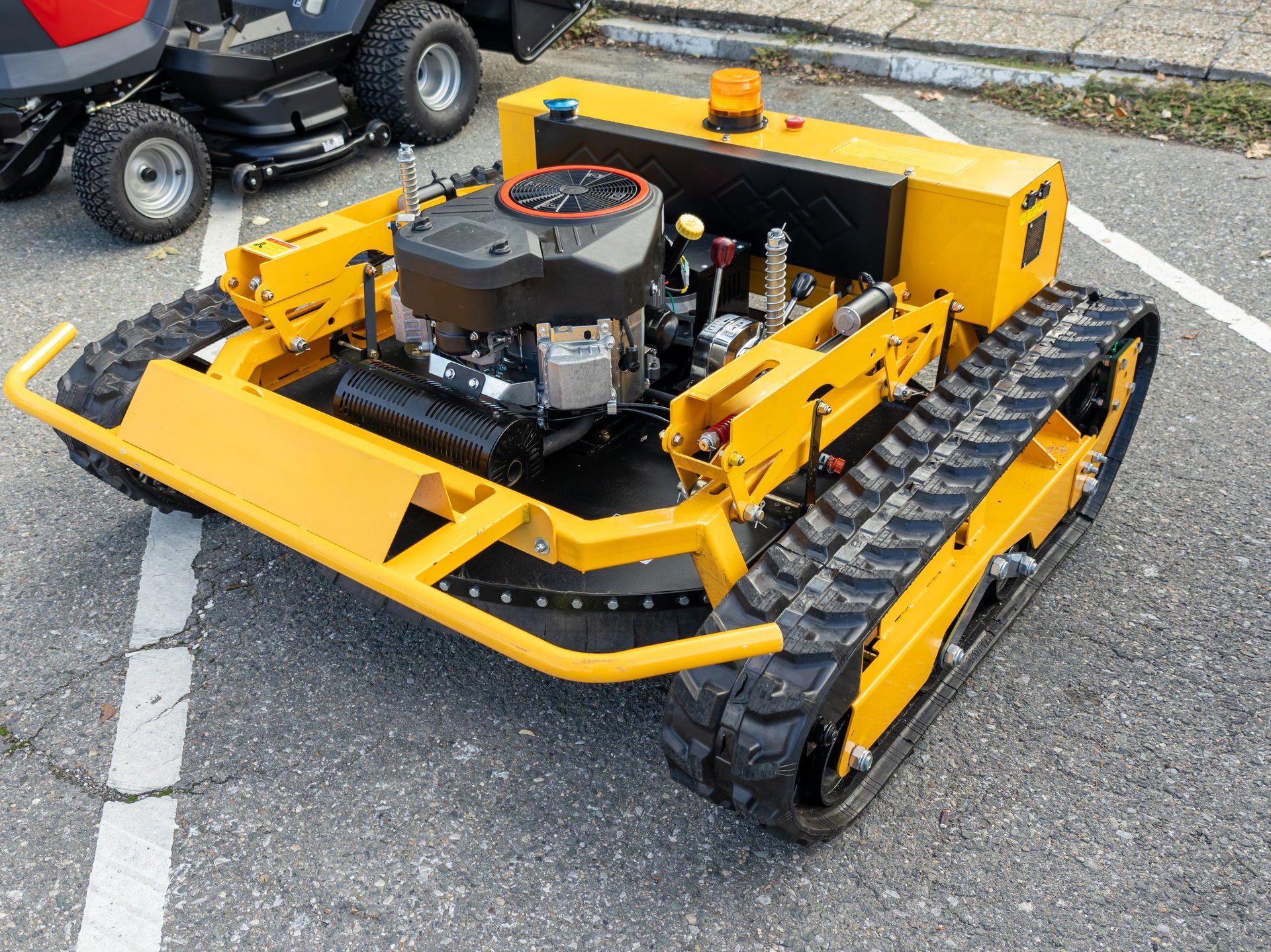 Modern remote-controlled track lawn mower for rough terrain
